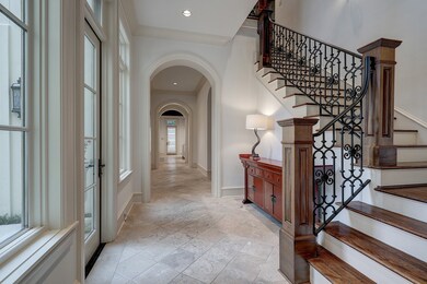 Beautiful stone flooring and arches along this lig