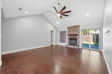 Unfurnished living room featuring a fireplace, high vaulted ceiling, dark wood-style floors, ceiling fan, and recessed lighting