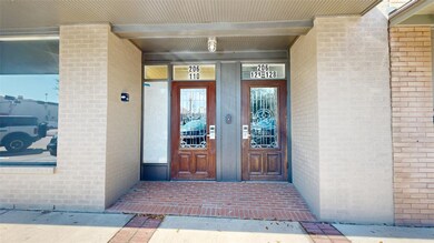 Doorway to property with brick siding