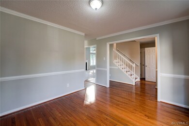 Spare room featuring hardwood floors, ornamental m