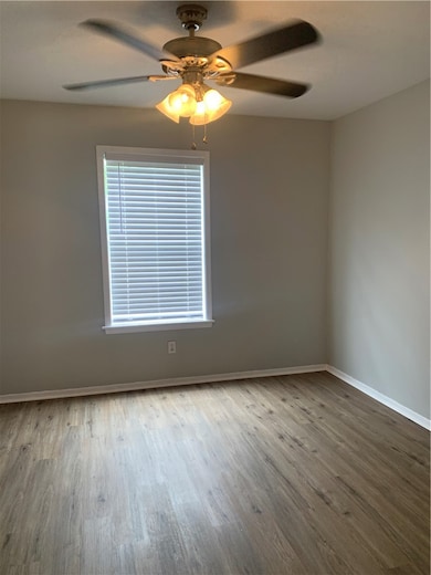 Unfurnished room with wood finished floors, basebo