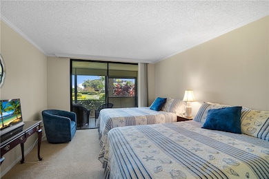 Spacious guest bedroom with adjacent bath and direct access to patio and green space outside. Split floorplan affords total privacy.