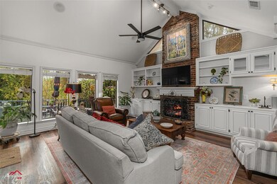 Living room with beam ceiling, wood-type flooring,