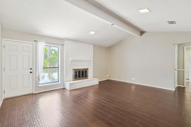 Unfurnished living room featuring vaulted ceiling 