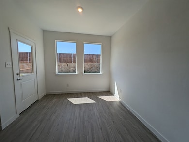 Unfurnished room featuring dark wood-type flooring and baseboards