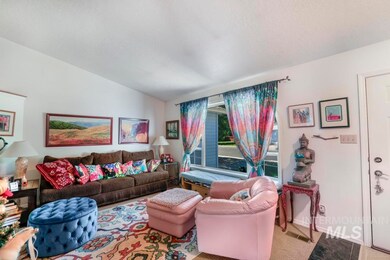 Living room featuring vaulted ceiling and baseboards