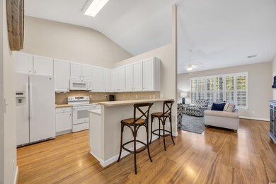 Kitchen featuring white appliances, white cabinets