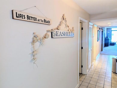 Corridor with baseboards and light tile patterned 
