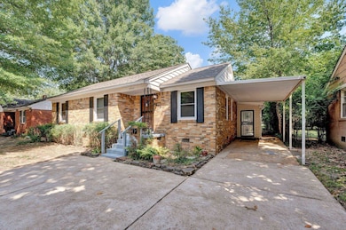 Single story home featuring a carport