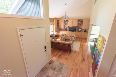 living room with high vaulted ceiling and light wood-type flooring