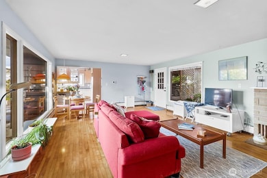 Open-concept living space showcases sightlines to dining and outdoor areas, creating easy flow throughout the main level.