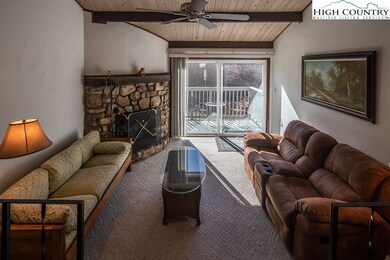 Living room, gas log fireplace and deck access to