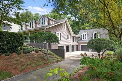 View of front facade featuring a garage and driveway