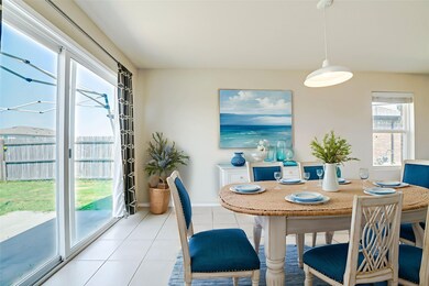 Tiled dining room featuring a sunroom