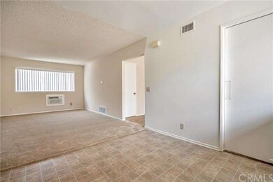 Standing in the kitchen, family room on the left. 