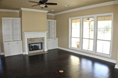 The open living/ kitchen/ dining area features har