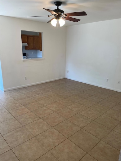 Unfurnished room featuring a ceiling fan and base