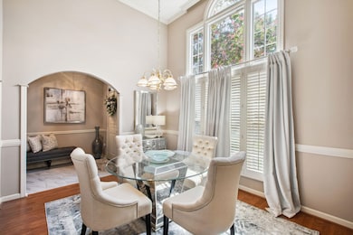 Dining space with wood-type flooring, a chandelier
