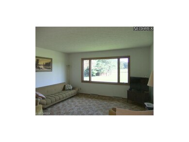 The spacious living room offers a large picture wi