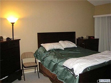 master bedroom with a walk-in closet, vaulted ceil
