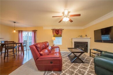 The living room is outfitted with neutral-toned wa