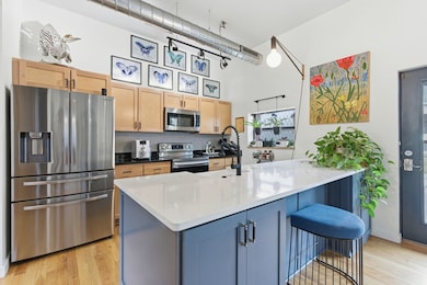 Kitchen is bright + sunny with a beautiful quartz island that offers storage below