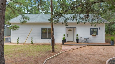 Ranch-style home featuring central AC and metal r
