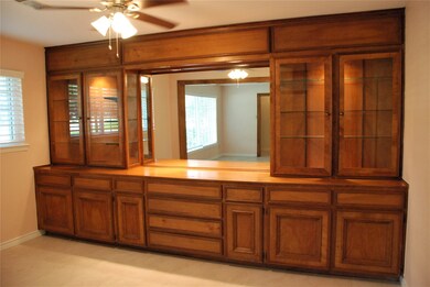 This custom built buffet offers lower cabinets and drawers for storage, as well as upper glass cabinets with lighting to showcase your finest china.