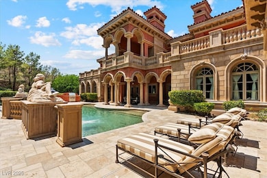 Rear view of property with a balcony, a patio area