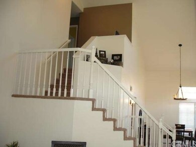 Stairway to the second level, with art niche near 