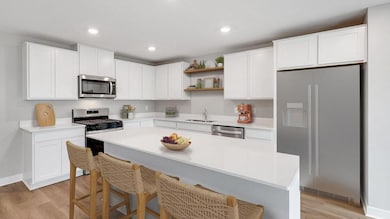 The bright and open kitchen is perfect for entertaining! Photo of actual home!