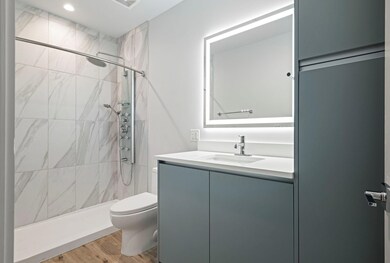 Full bath featuring toilet, vanity, wood finished