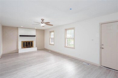 Unfurnished living room with ceiling fan, light wo