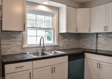 Tile backsplash and a window above the sink.