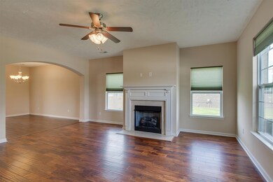 Living room has new hardwood floors, gas fireplace and lots of windows for natural light.  It is open to the kitchen/dining area