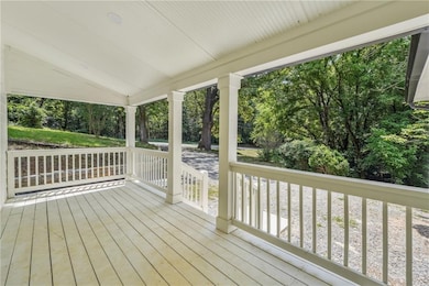 Porch with view of wooded area