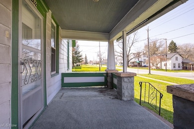 Porch with a residential view and a lawn