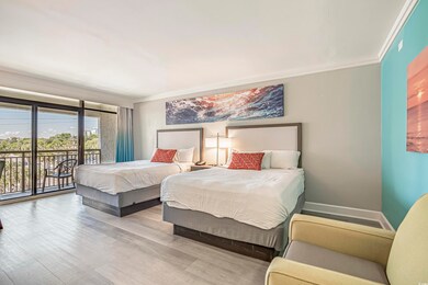 Bedroom featuring access to exterior, wood finished floors, and ornamental molding