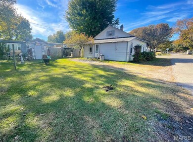 Rear view of property with a chimney and an outdoor structure