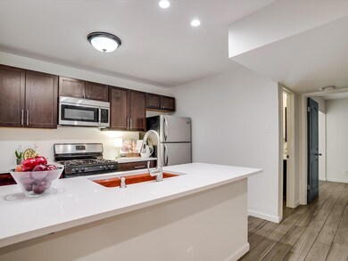 Kitchen with dark brown cabinetry, light countert