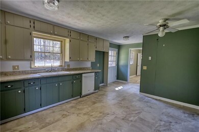 Kitchen with a ceiling fan, a sink, white dishwash