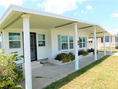 Front of home with patio sitting area.