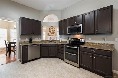 The kitchen is stunning with granite countertops, 