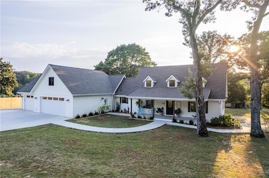 View of front facade featuring a shingled roof, a 