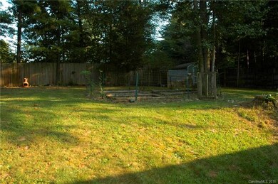 View of back yard from deck. Garden spot, fencing 