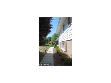 Newer plantings flank the walkway to the front doo
