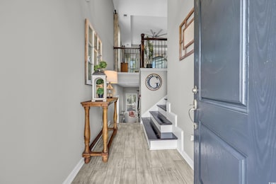 Foyer featuring stairs and wood finished floors