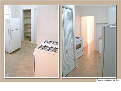 Kitchen downstairs with fridge & gas stove.