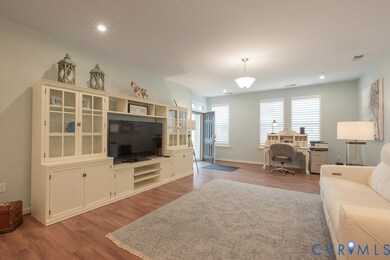 Living area featuring an office area, light wood finished floors, and recessed lighting