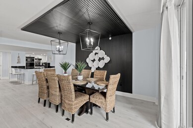 Dining area featuring a notable chandelier and lig
